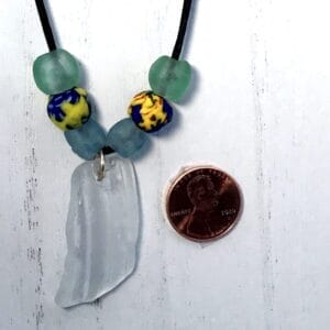 Clear vertically ridged sea glass necklace on black satin cord