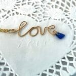 gold cursive love necklace view