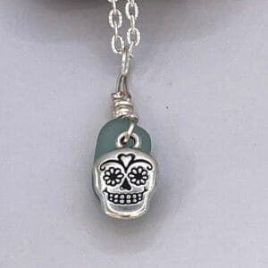 Aqua sea glass with sugar skull charm