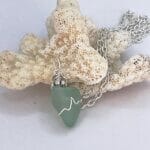 Aqua sea glass with silver wire wrap necklace, close up