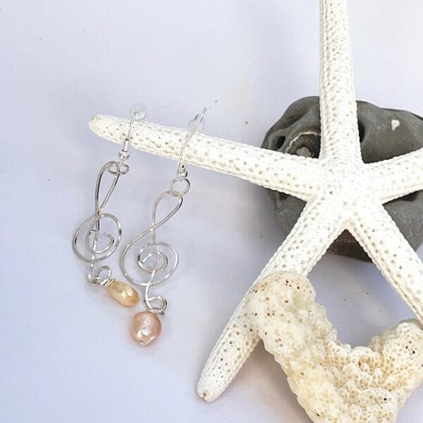 Treble clef earrings with pearl accent, view