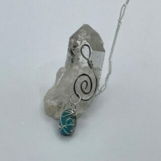 Light teal sea glass on silver swirl necklace