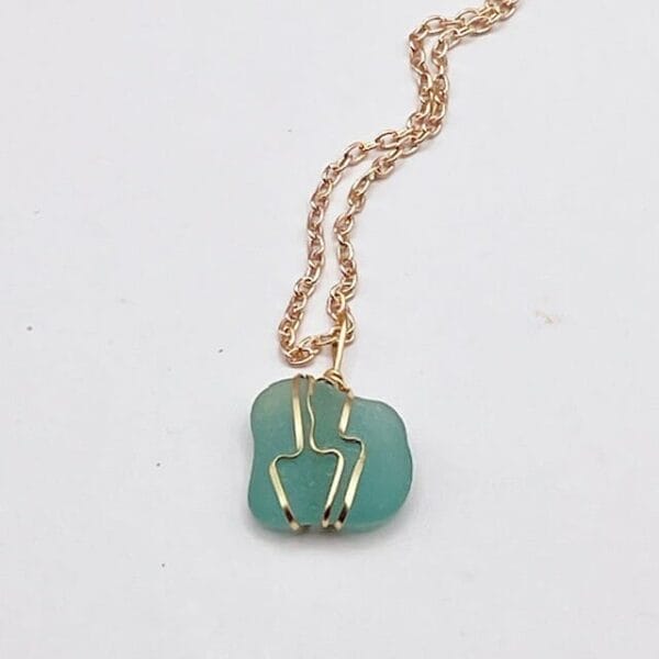 Teal sea glass in gold wire wrap