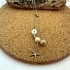 Pearl lariat with gold starfish, view