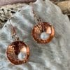 Copper pearl earrings, close up