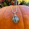 Teal heart sea glass necklace on pumpkin