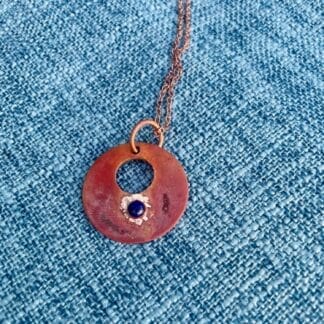 Copper disc necklace close up