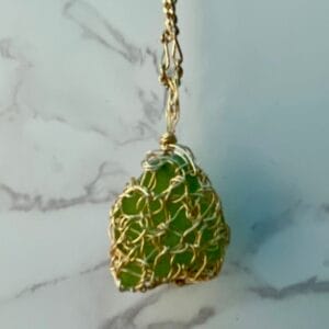 Green sea glass in gold crochet necklace