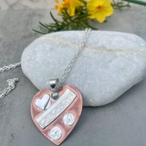 Quilted copper heart necklace, flat view