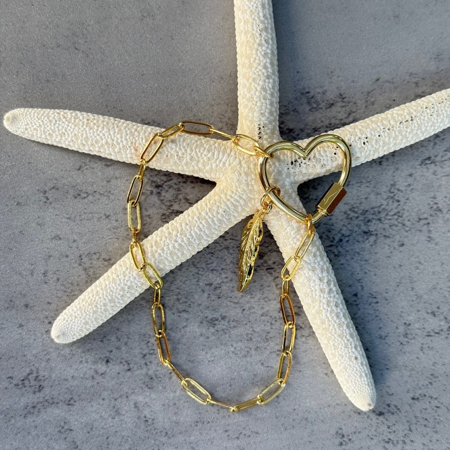 Gold heart carabiner bracelet with feather charm